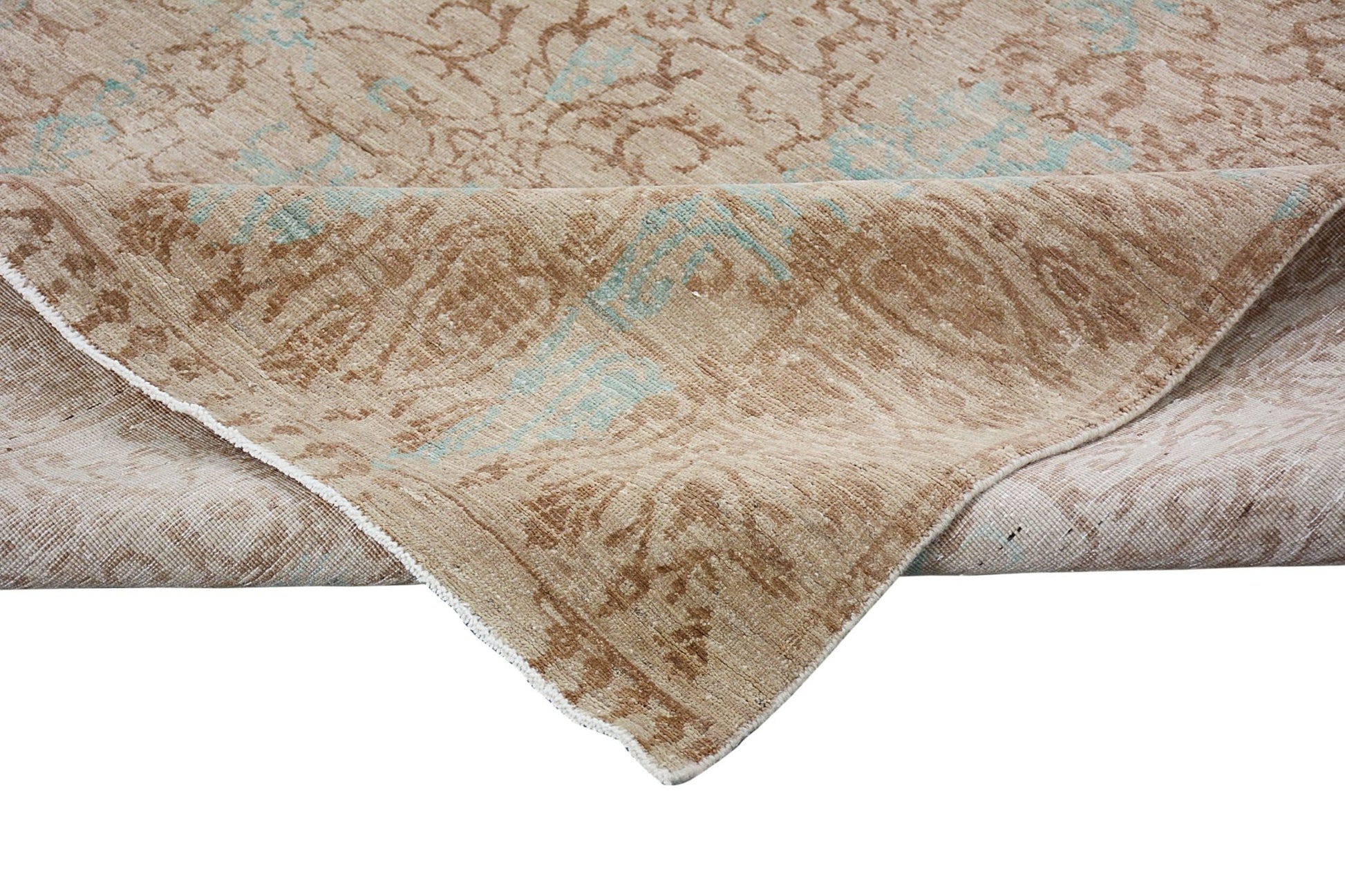 A handmade Afghan Chobi rug featuring a traditional floral pattern in beige and soft blue tones.