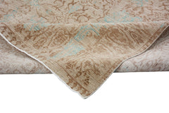 A handmade Afghan Chobi rug featuring a traditional floral pattern in beige and soft blue tones.