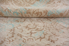 A handmade Afghan Chobi rug featuring a traditional floral pattern in beige and soft blue tones.
