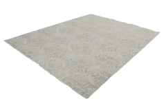 A handmade Afghan Chobi rug featuring a traditional floral pattern in soft beige and grey tones.