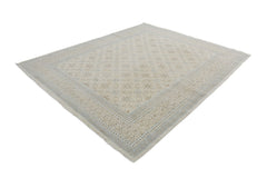 A handmade Afghan Chobi rug featuring a traditional floral pattern in neutral beige and blue tones.