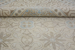 A handmade Afghan Chobi rug featuring a light beige field with soft blue and tan floral patterns.