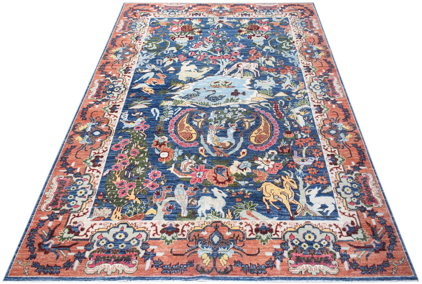 A rectangular Afghan Chobi rug featuring a blue field with intricate floral and animal motifs.