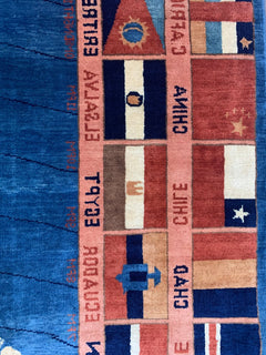 A handmade Afghan Chobi rug featuring a grid of international flags with text labels.