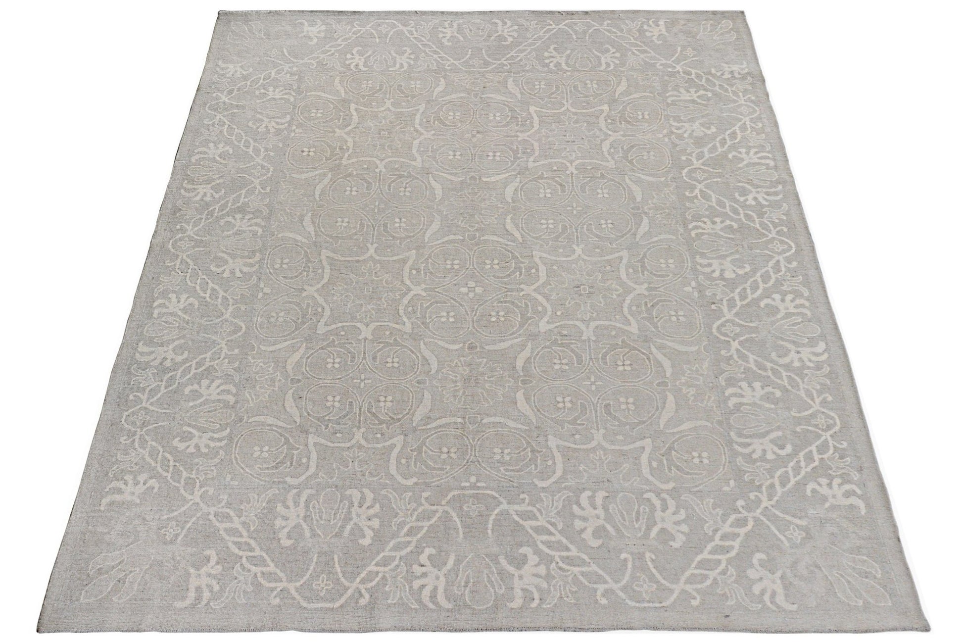 A handmade Afghan Chobi rug featuring a light grey floral pattern on a wool pile.