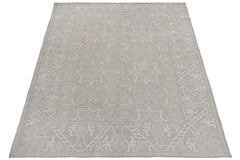 A handmade Afghan Chobi rug featuring a light grey floral pattern on a wool pile.