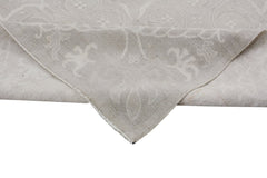 A handmade Afghan Chobi rug featuring a neutral, monochromatic floral pattern on handspun wool.