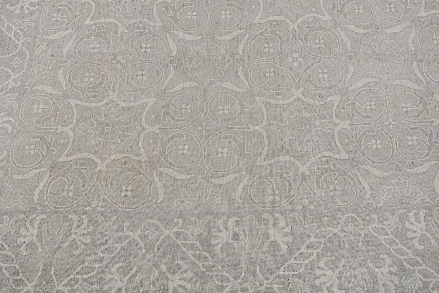 A handmade Afghan Chobi rug featuring a traditional light grey floral and geometric pattern.