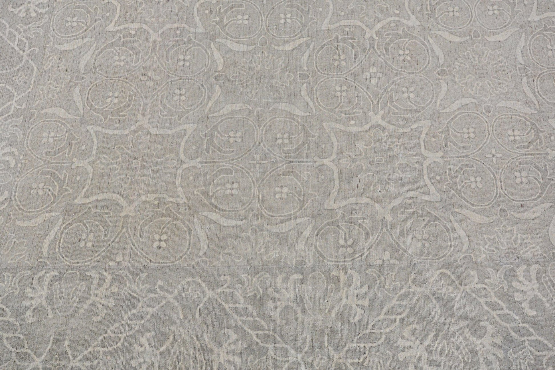 A handmade Afghan Chobi rug featuring a traditional light grey floral and geometric pattern.