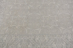 A handmade Afghan Chobi rug featuring a traditional light grey floral and geometric pattern.
