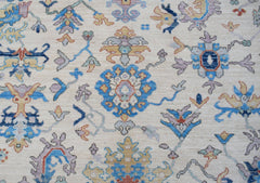A handmade Afghan Chobi rug featuring a traditional floral pattern in blue, gold, and cream tones.