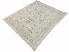 A handmade Afghan Chobi rug featuring a traditional floral pattern in soft blue and beige tones.