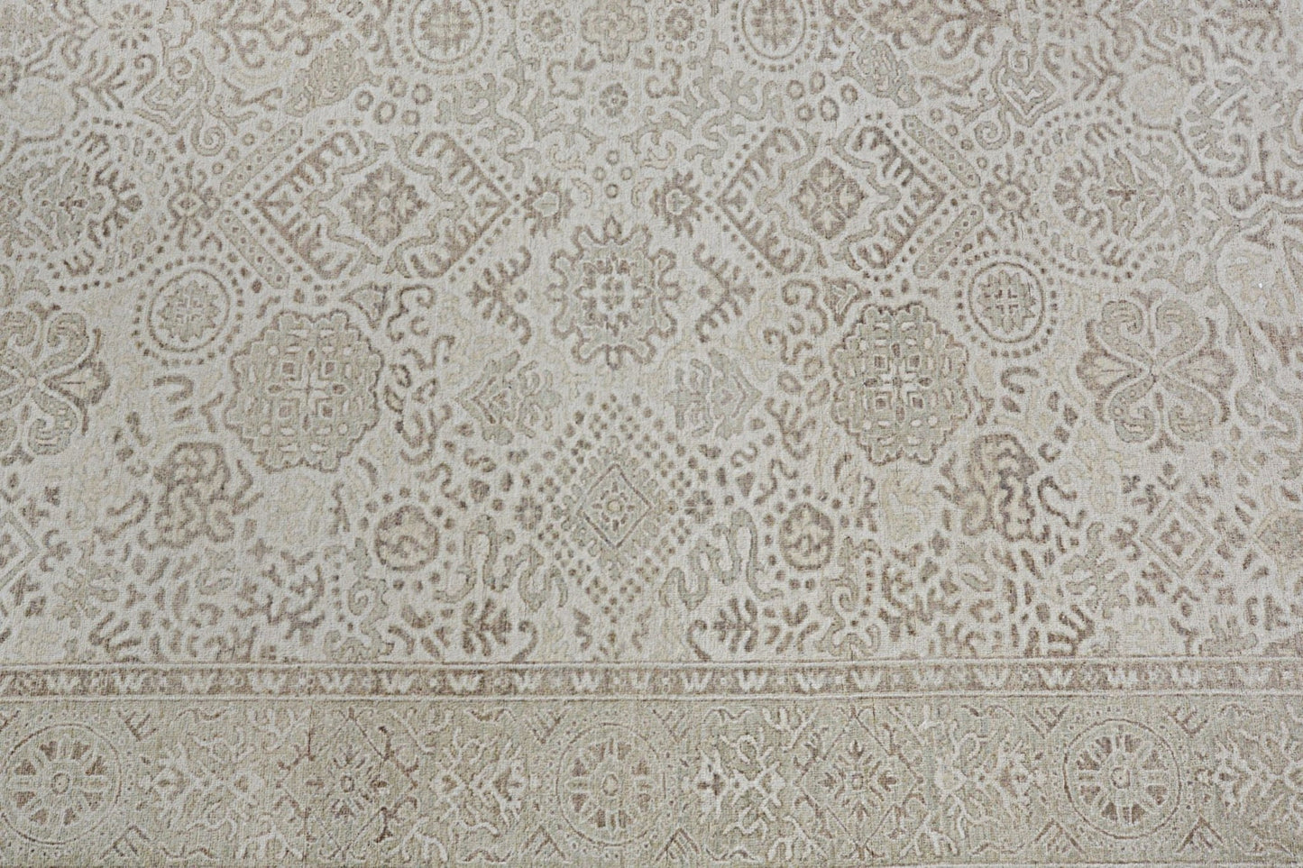 An Afghan Chobi rug featuring a traditional beige and brown geometric floral pattern.