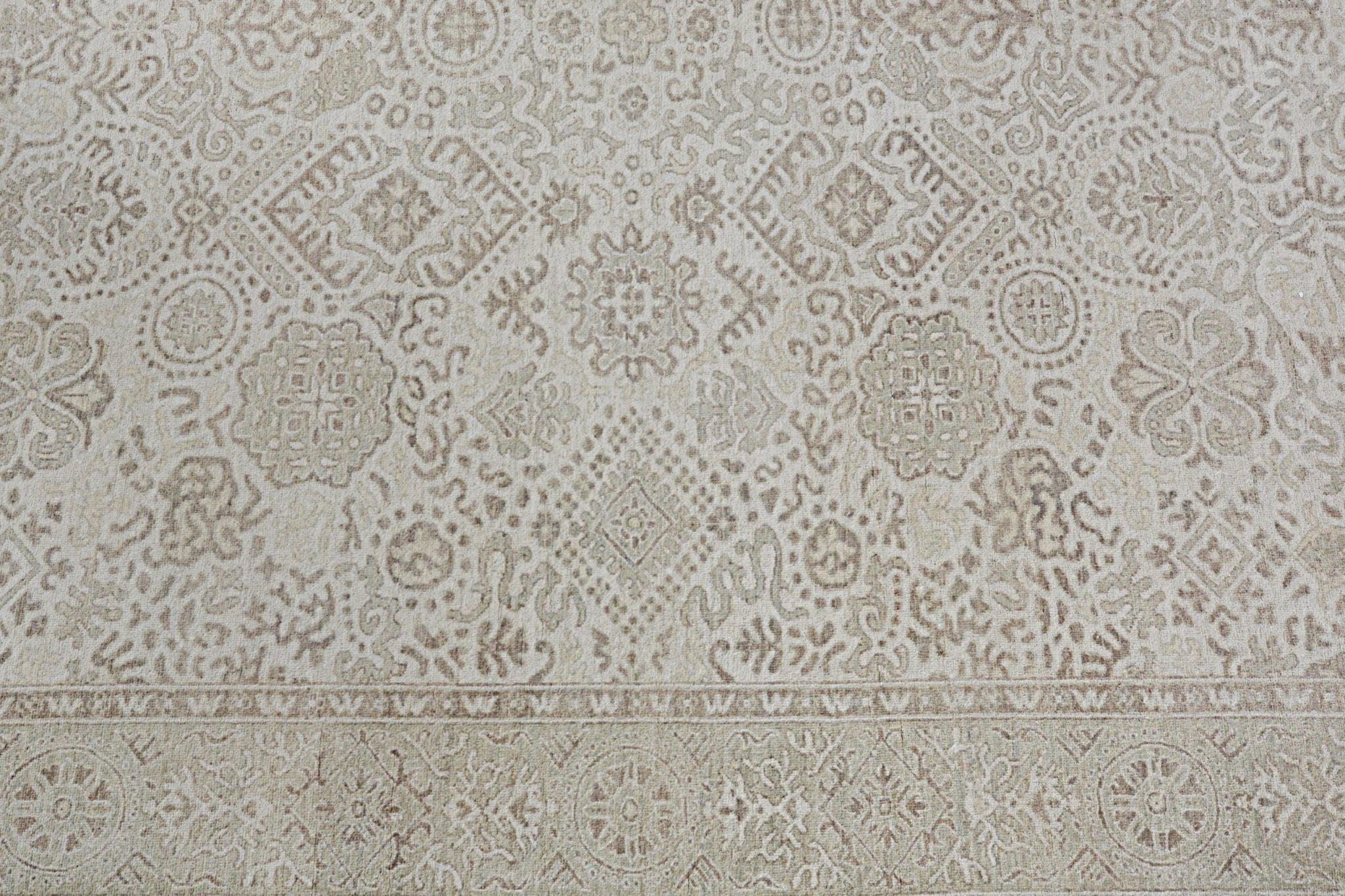 An Afghan Chobi rug featuring a traditional beige and brown geometric floral pattern.