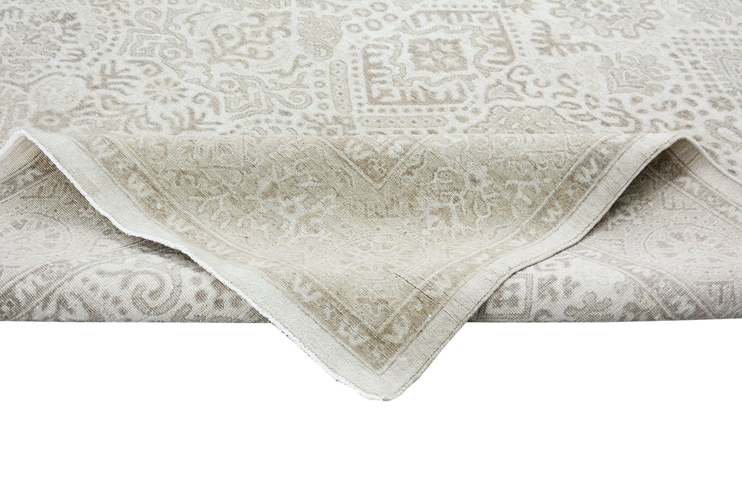 A handmade Afghan Chobi rug with a traditional beige and cream patterned design.