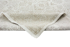A handmade Afghan Chobi rug with a traditional beige and cream patterned design.