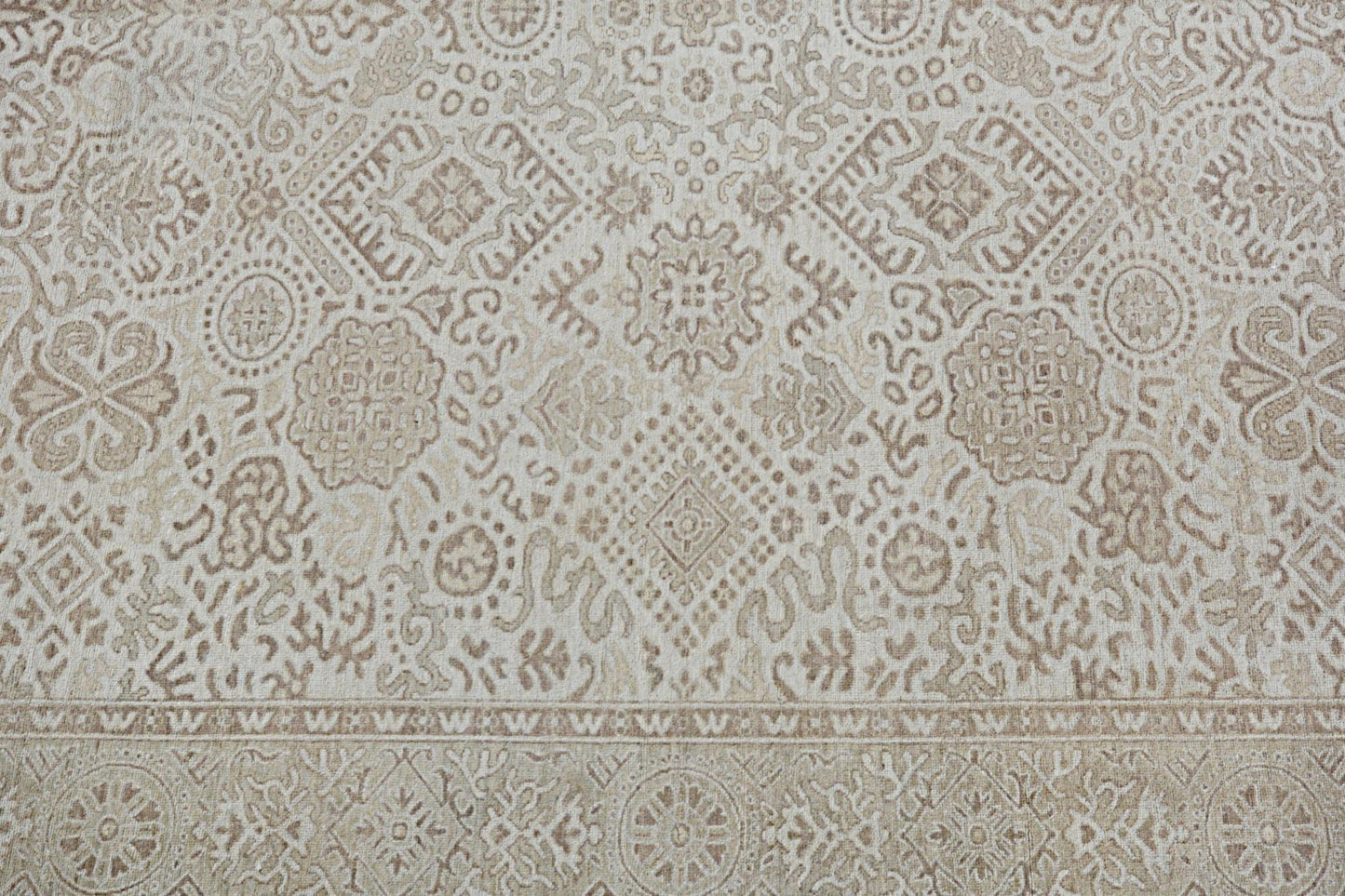 A handmade Afghan Chobi rug featuring a traditional beige and brown geometric floral pattern.