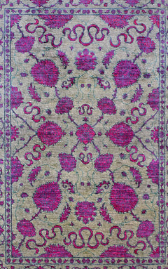 Handwoven Afghan Chobi rug featuring a symmetrical floral pattern in magenta on a beige background.