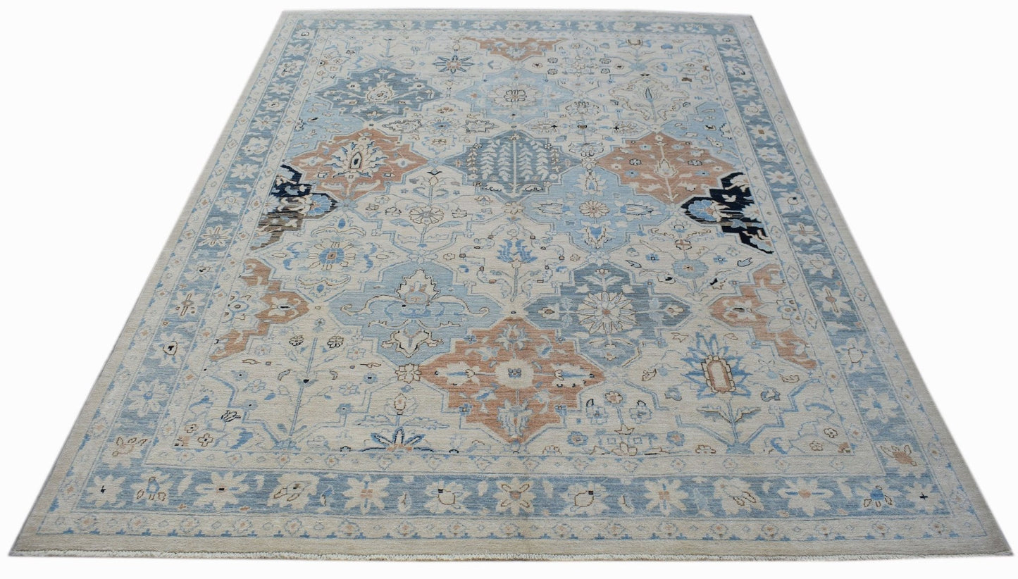 A handmade Afghan Chobi rug featuring a traditional floral pattern in shades of blue and tan.