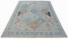 A handmade Afghan Chobi rug featuring a traditional floral pattern in shades of blue and tan.