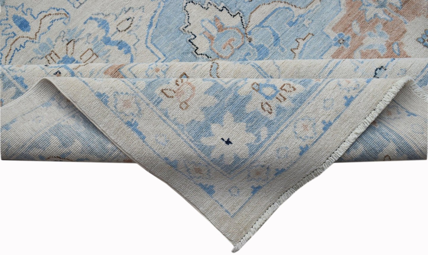 A handwoven Afghan Chobi rug featuring a traditional floral pattern in blue and beige tones.