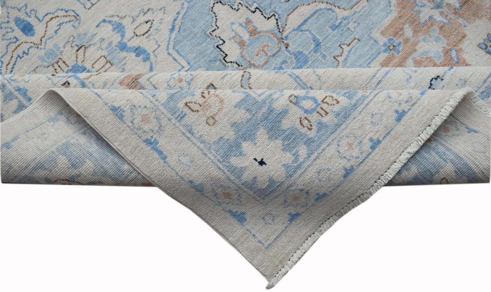 A handwoven Afghan Chobi rug featuring a traditional floral pattern in blue and beige tones.