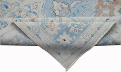 A handwoven Afghan Chobi rug featuring a traditional floral pattern in blue and beige tones.