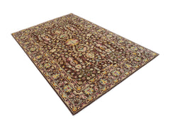 An Afghan Chobi rug featuring a traditional floral pattern in earthy tones on a brown background.