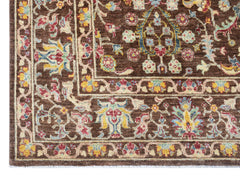 Handwoven Afghan Chobi rug featuring a traditional floral pattern in earthy tones on a brown base.