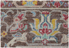 A close-up of an Afghan Chobi rug featuring intricate floral patterns in earthy tones.