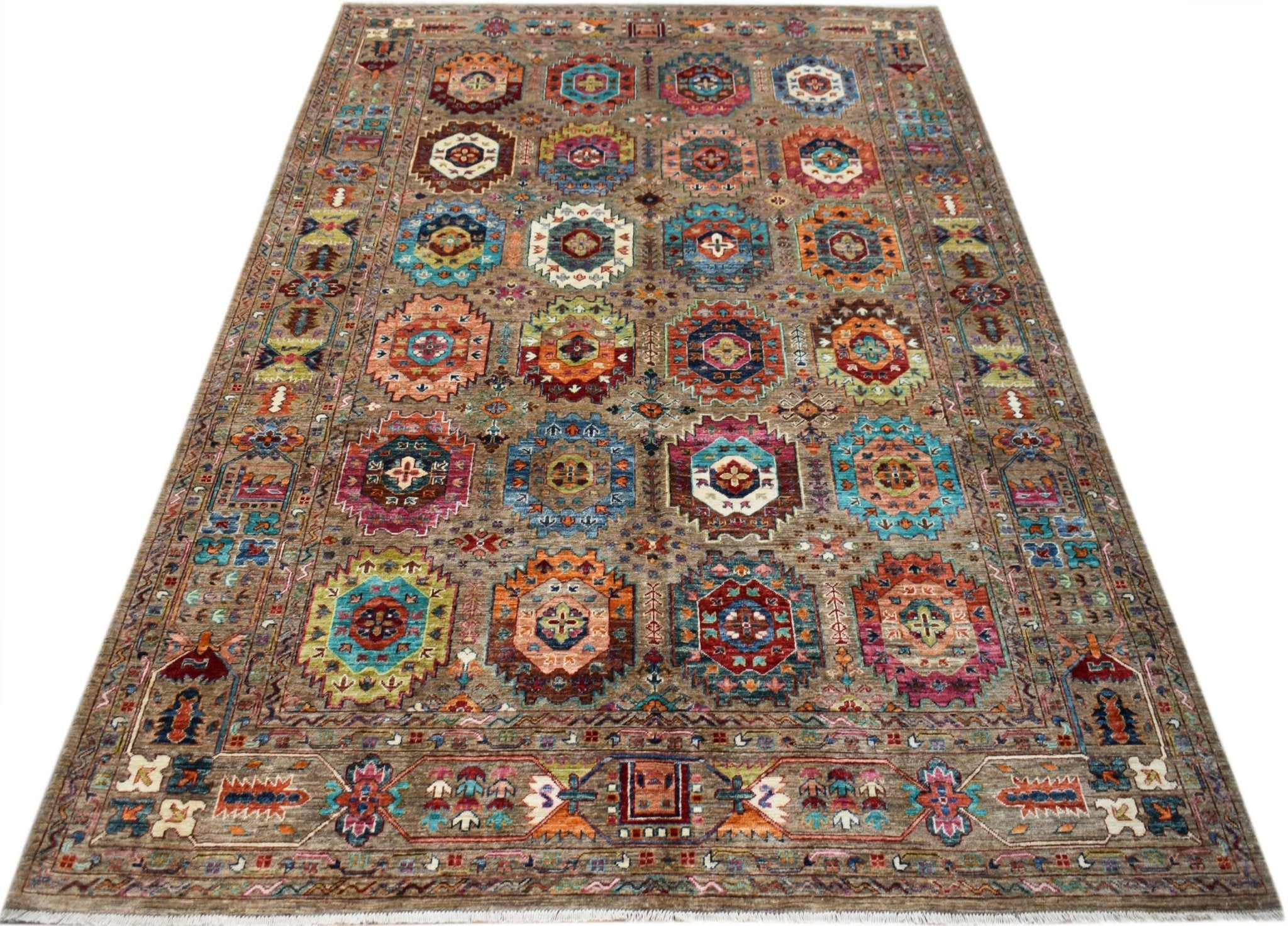 Handwoven Afghan Chobi rug featuring a repeating geometric medallion pattern in earthy tones.