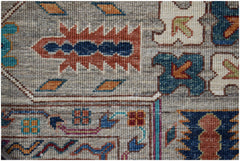 A close-up of an Afghan Chobi rug featuring intricate geometric patterns in earthy tones.