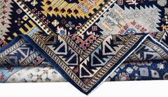 A handwoven Afghan Chobi rug featuring intricate geometric patterns in blue, gold, and cream tones.