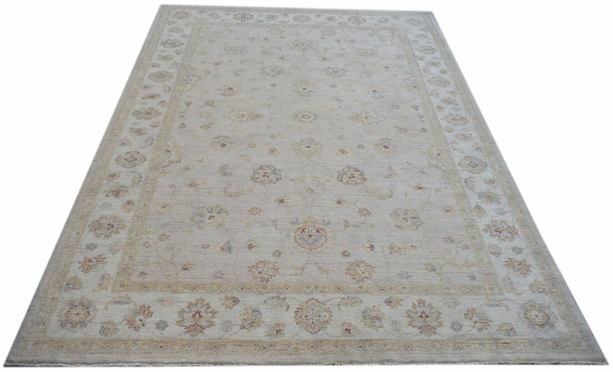 An Afghan Chobi rug featuring a traditional floral pattern in soft, neutral wood tones.