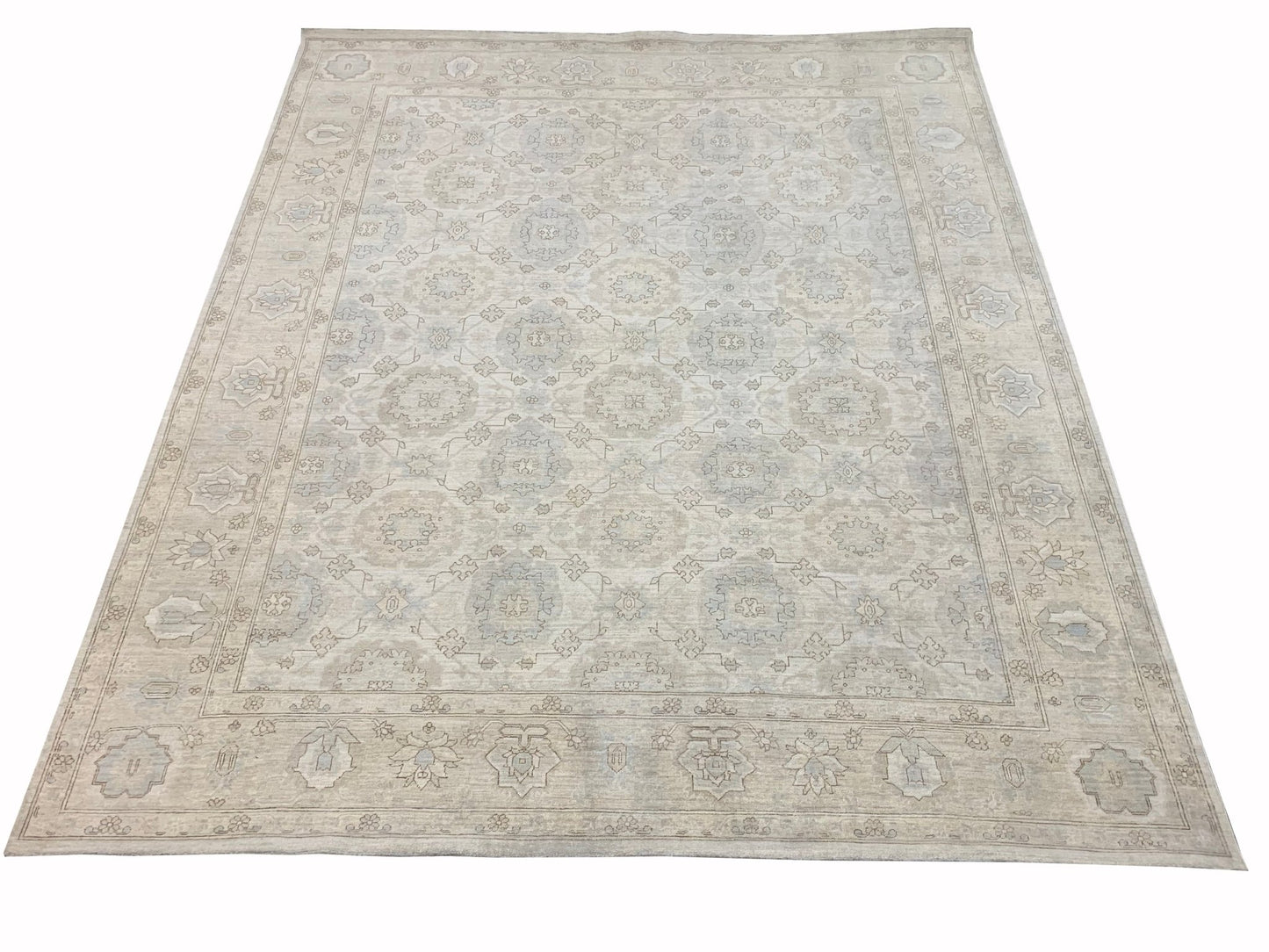 A handmade Afghan Chobi rug featuring a traditional floral pattern in soft beige and blue tones.