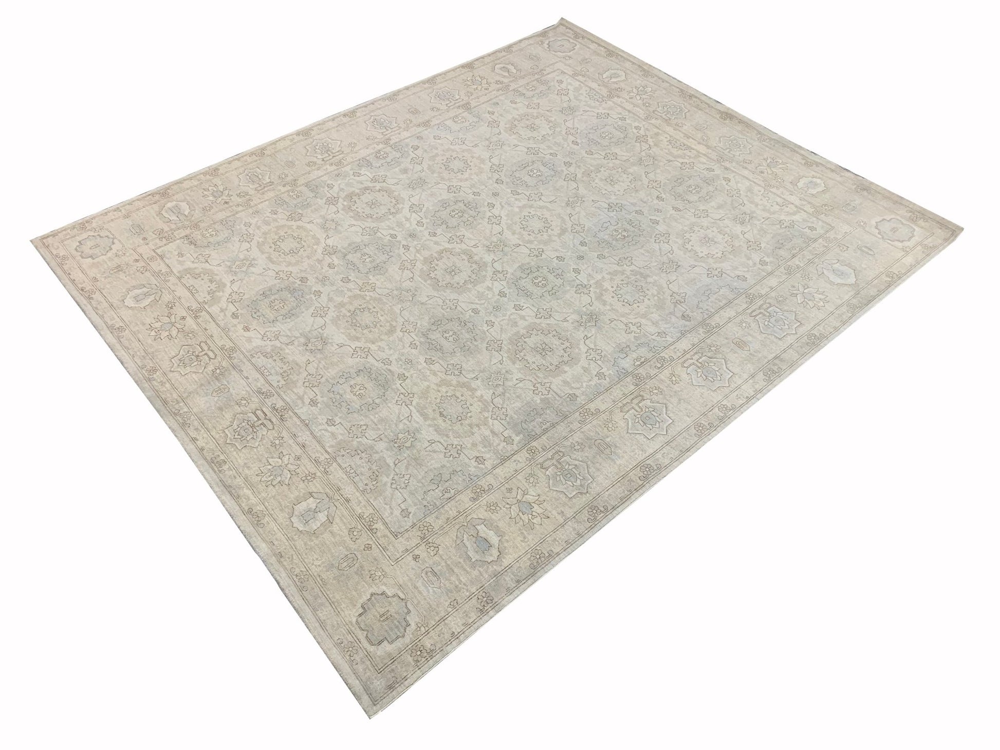 A handmade Afghan Chobi rug featuring a traditional floral pattern in soft neutral tones.