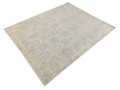 A handmade Afghan Chobi rug featuring a traditional floral pattern in soft neutral tones.