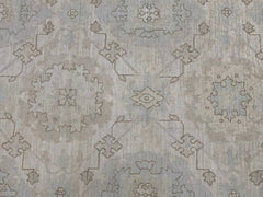 An Afghan Chobi rug featuring a traditional geometric floral pattern in soft neutral tones.