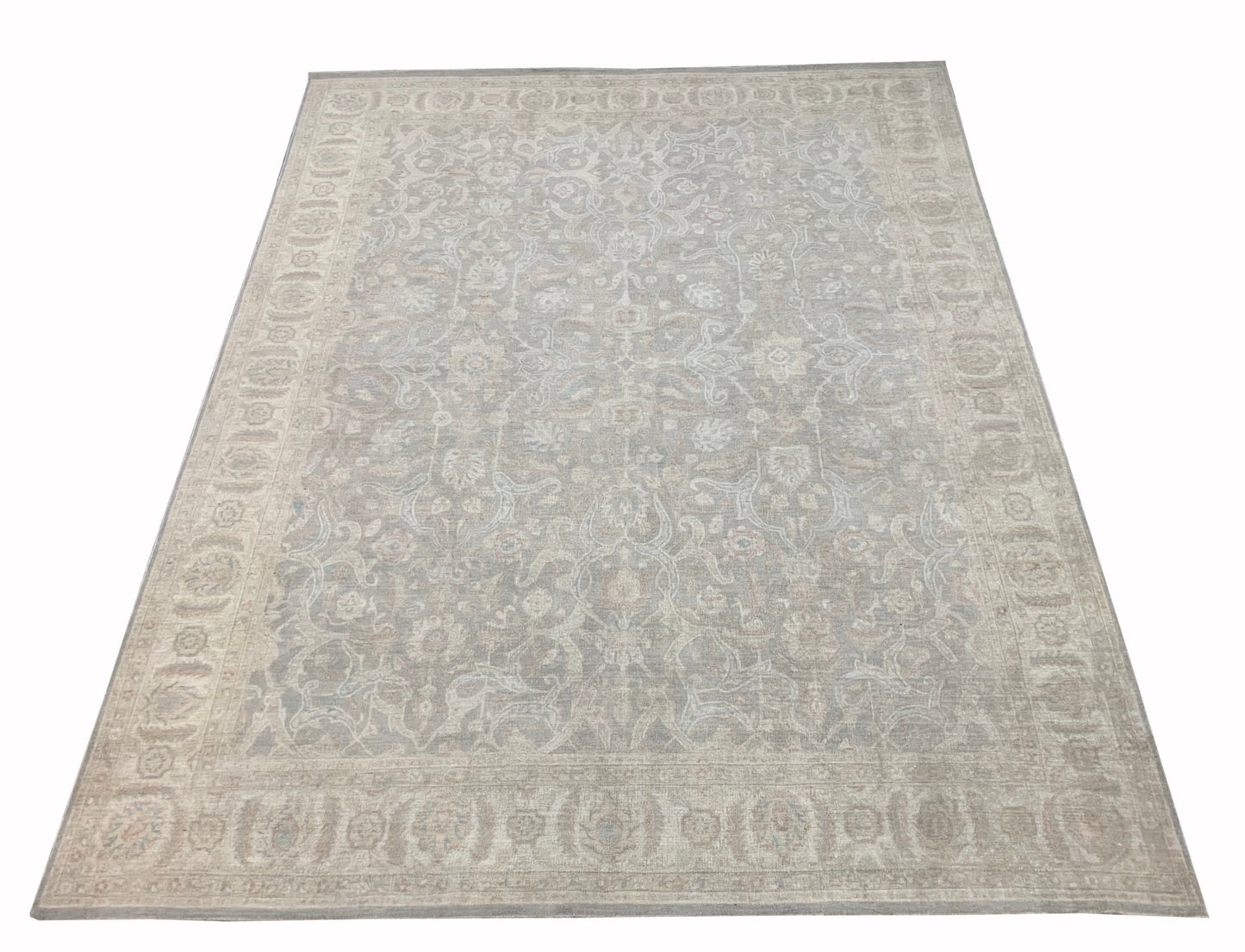 An Afghan Chobi rug featuring a traditional floral pattern in muted beige and grey tones.