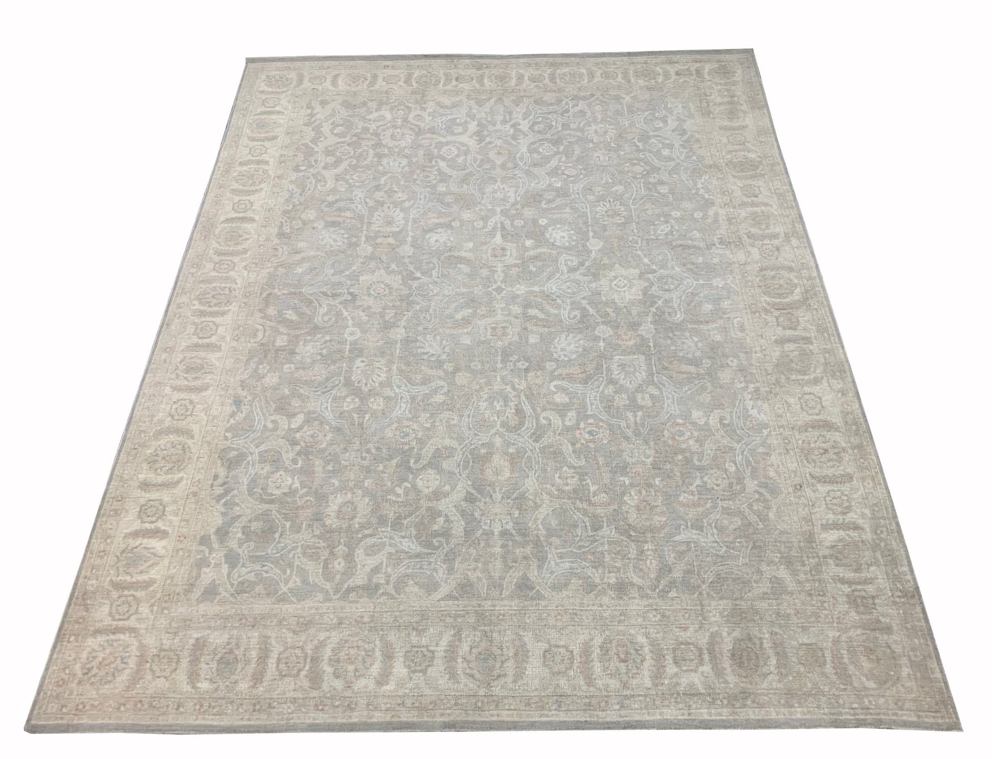 An Afghan Chobi rug featuring a traditional floral pattern in muted beige and grey tones.