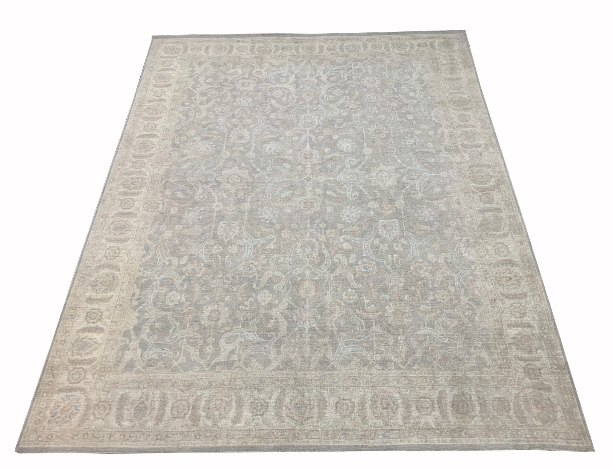 An Afghan Chobi rug featuring a traditional floral pattern in muted beige and grey tones.