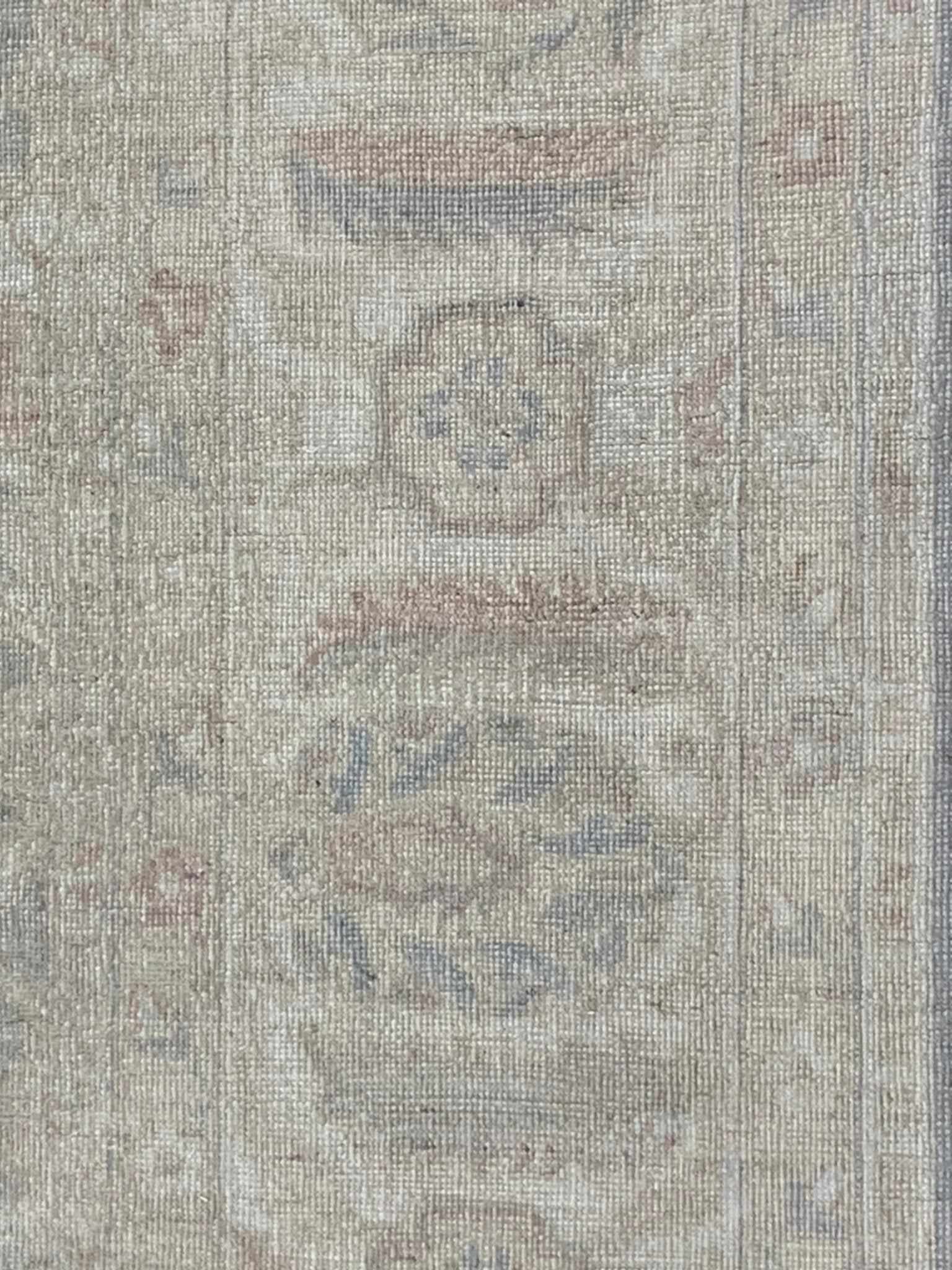 A handmade Afghan Chobi rug featuring traditional floral patterns in soft, neutral wood tones.