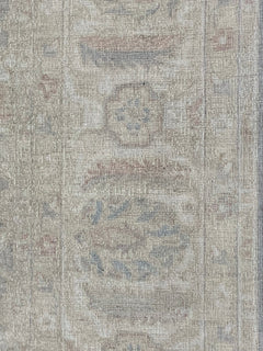 A handmade Afghan Chobi rug featuring traditional floral patterns in soft, neutral wood tones.