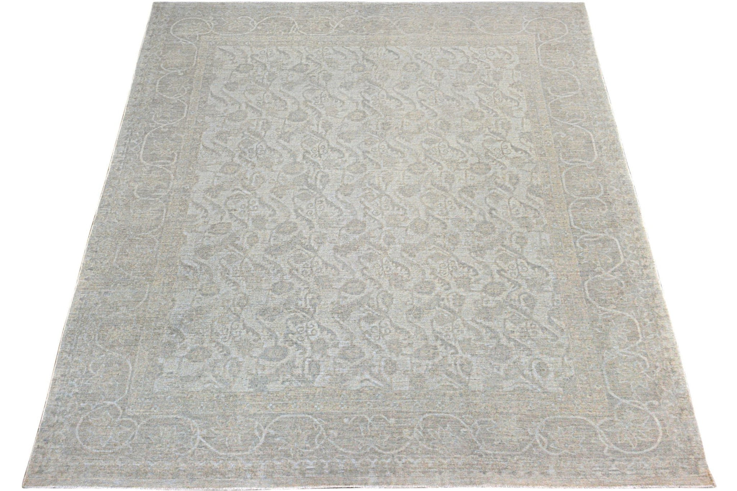 A handmade Afghan Chobi rug featuring a traditional floral pattern in soft neutral tones.