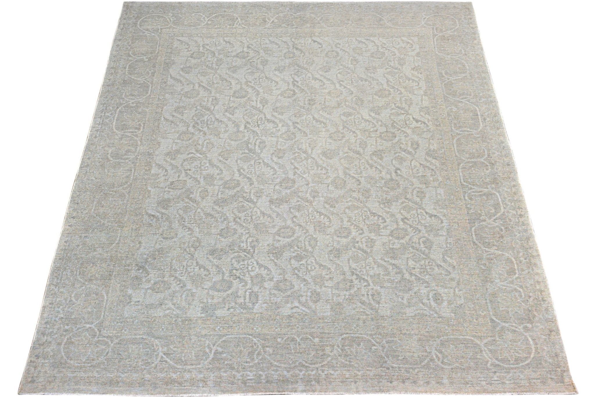 A handmade Afghan Chobi rug featuring a traditional floral pattern in soft neutral tones.