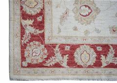 A handmade Afghan Chobi rug featuring a traditional floral pattern in red and cream tones.
