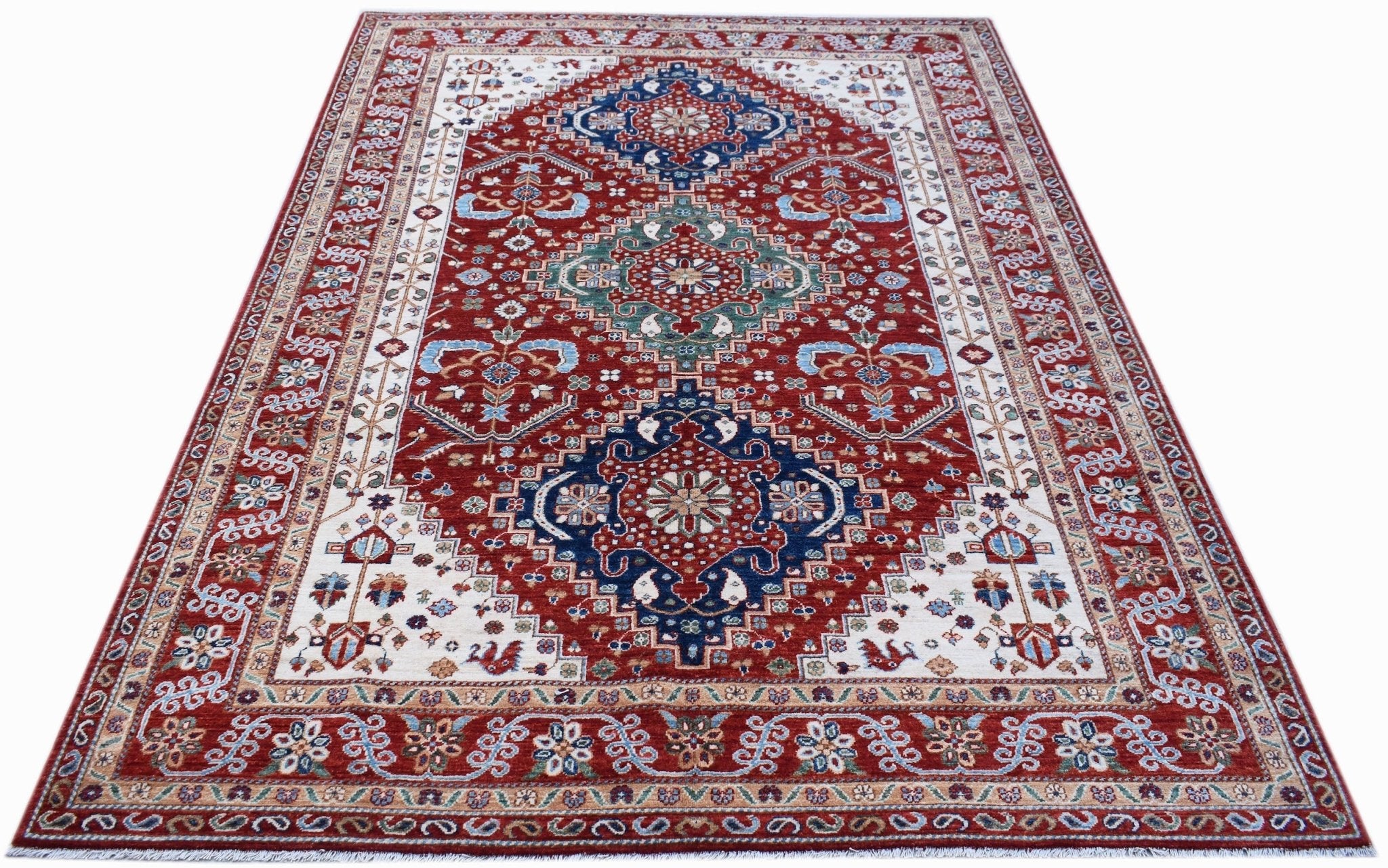 A rectangular Afghan Chobi rug featuring a traditional floral pattern in red, blue, and cream.