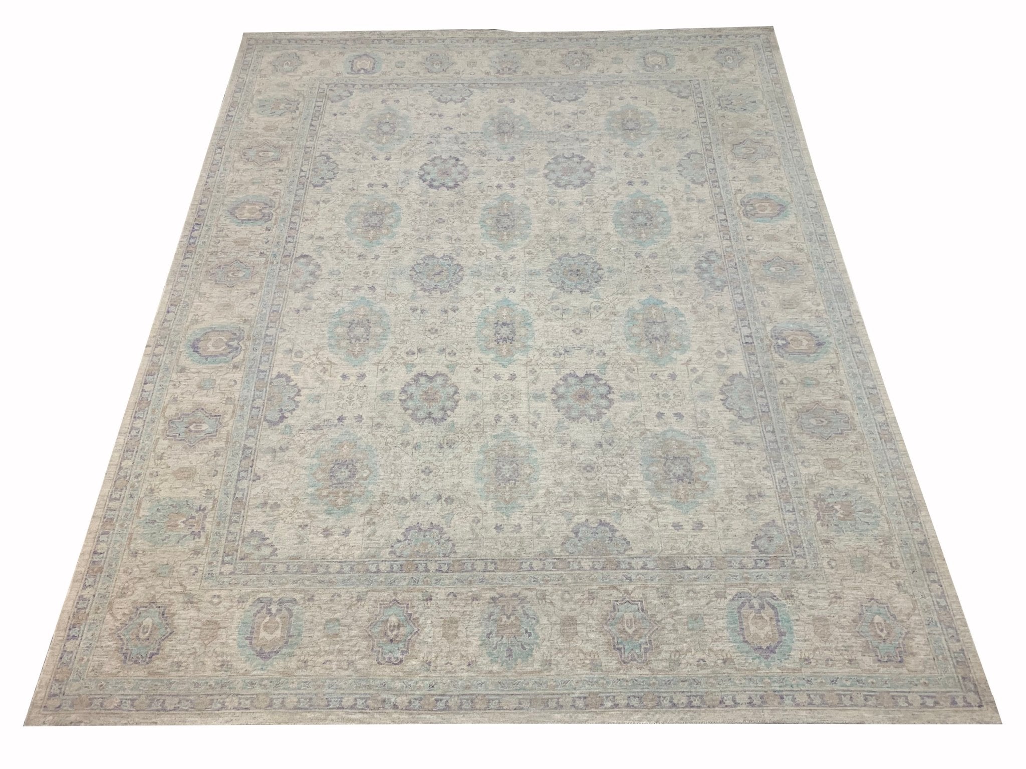 A handmade Afghan Chobi rug featuring a traditional floral pattern in soft beige and blue tones.