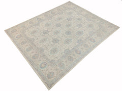 An Afghan Chobi rug featuring a traditional floral pattern in soft beige, blue, and grey tones.