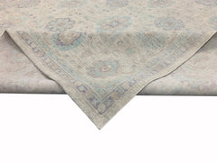 A handmade Afghan Chobi rug featuring a traditional floral pattern in soft beige, blue, and purple.